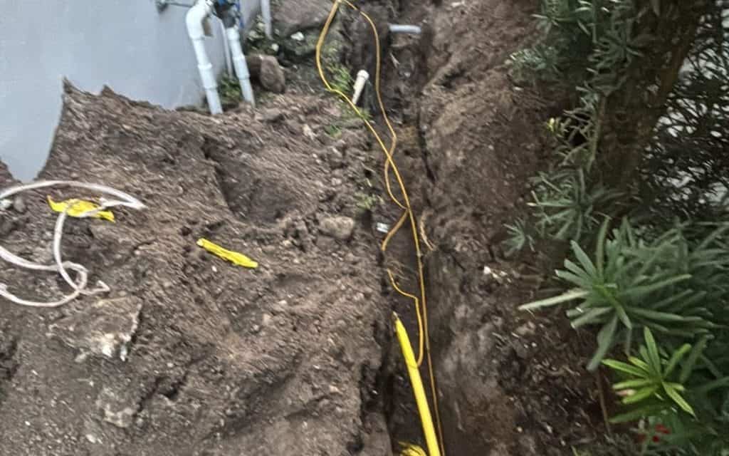 New water service line bored along a finished property line