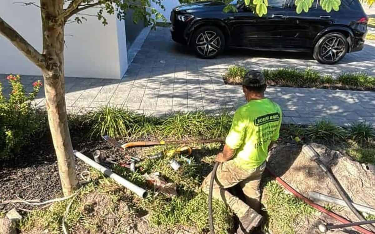Crew boring a gas-and-electric run under finished landscaping