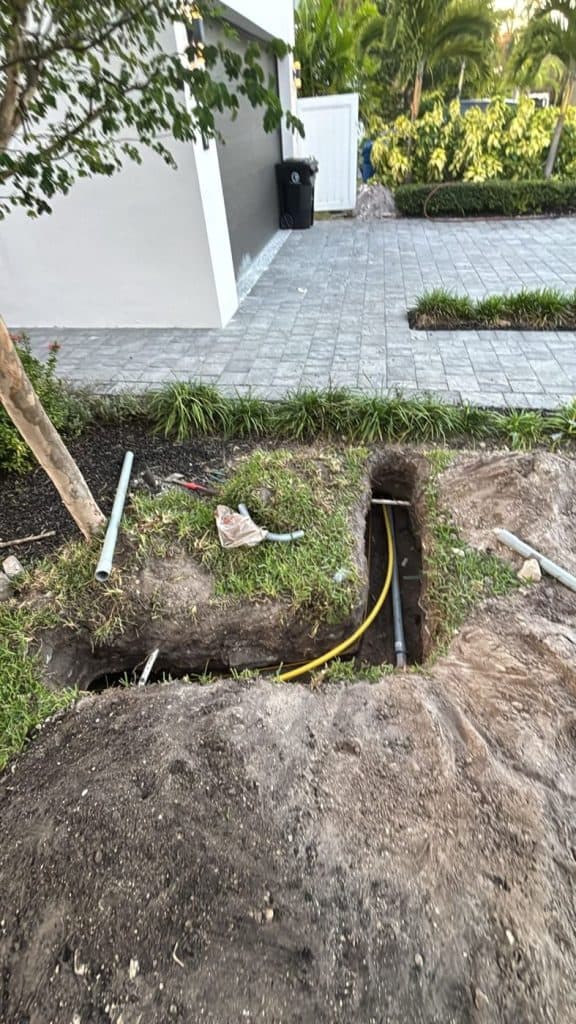 Underground conduit installed beside a finished paver driveway — serving Dalton, GA