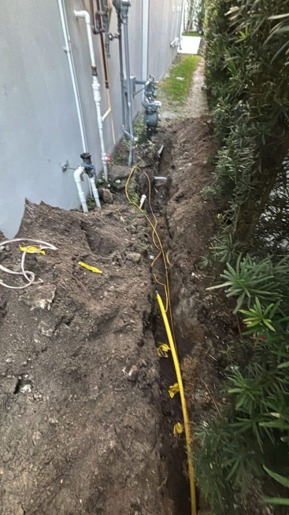 Gas service line placed along a landscaped property line — serving Tamarac, FL