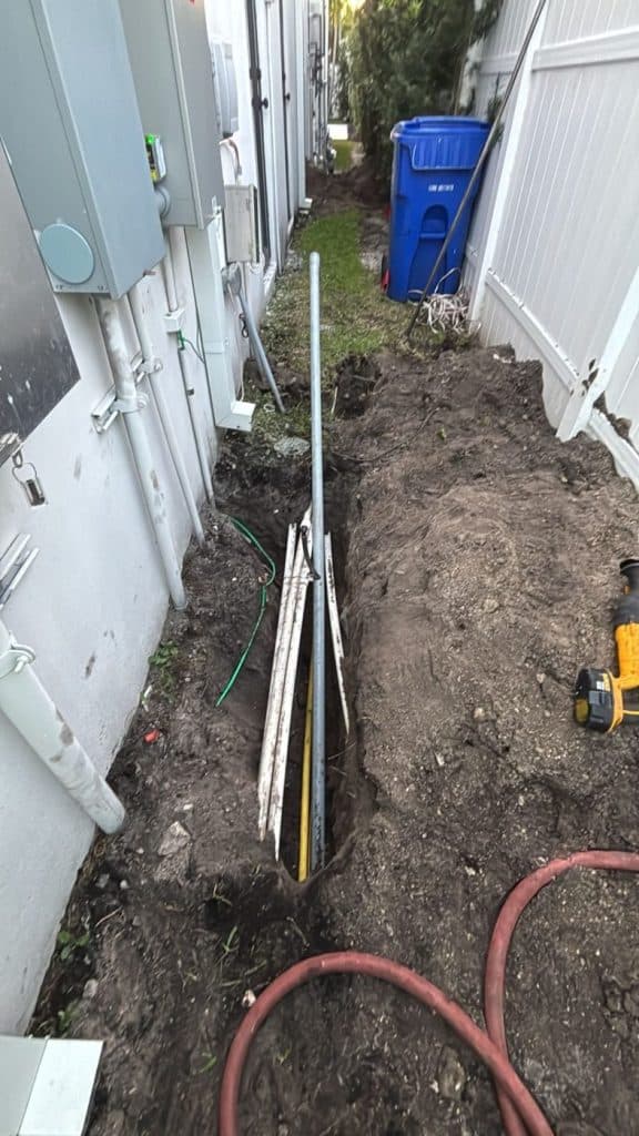 Utility trench with conduit and drilling tooling on site — serving Tampa, FL