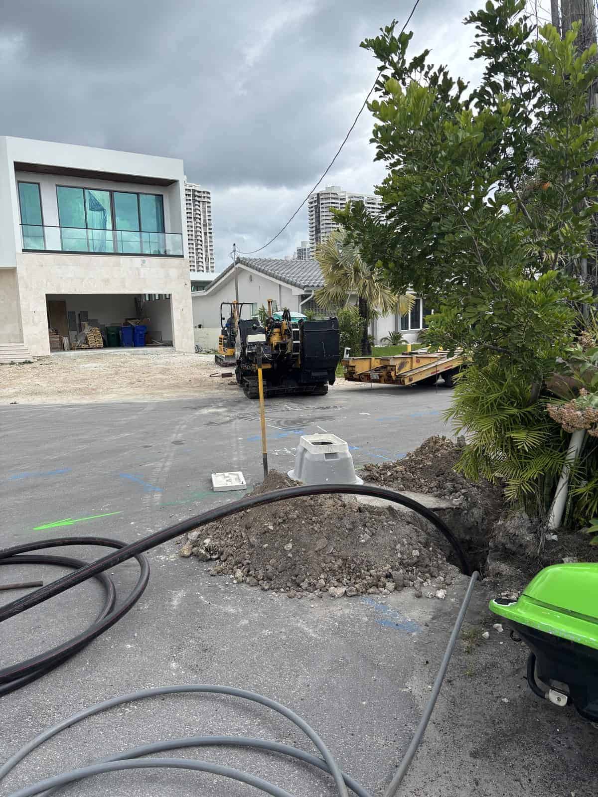 Construction site with machinery and new residential buildings under development.