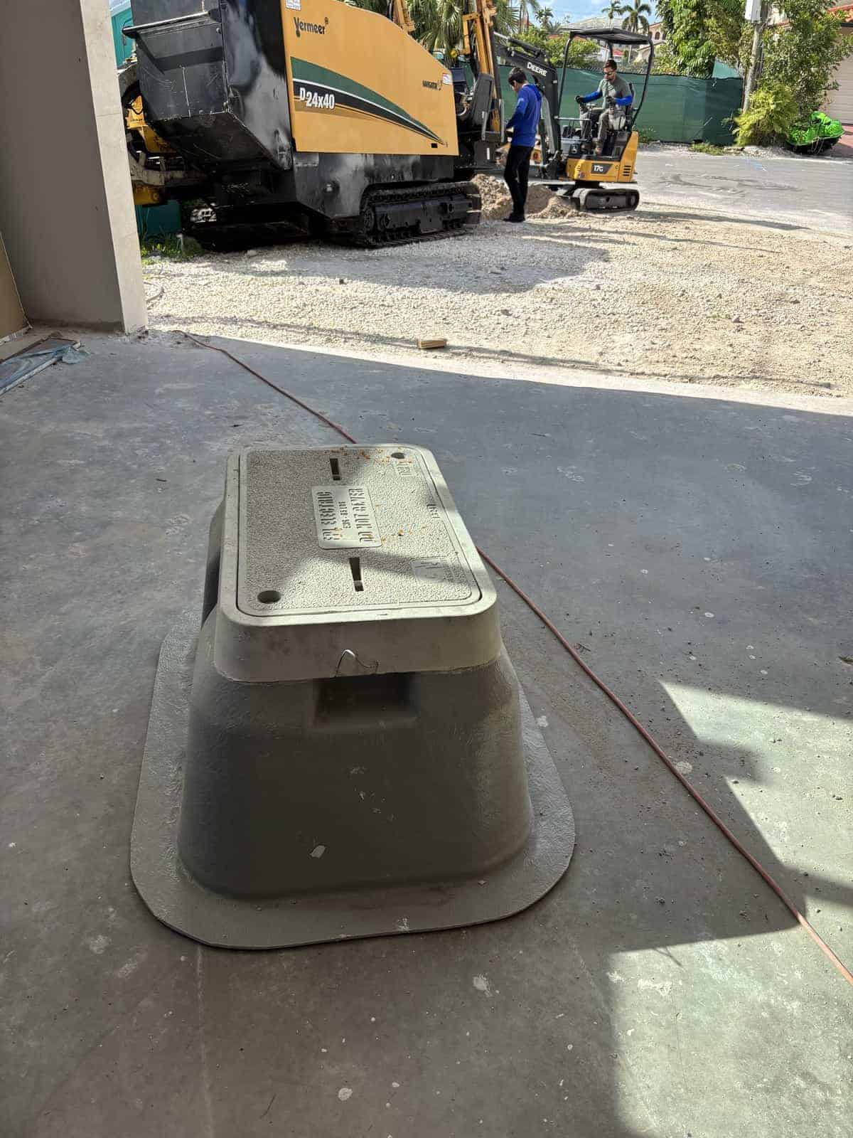 Construction site with heavy machinery and workers in the background.